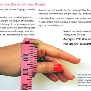 May include: A pink measuring tape wrapped around a wrist to demonstrate how to measure for a bangle. The text reads "To Determine the size of your Bangle" and includes instructions on how to measure your wrist. The text also states that most bangles come in two sizes: Average (8 inches in circumference) and Plus Size (9 inches in circumference).