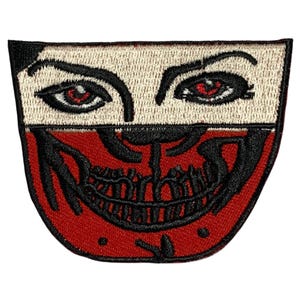 May include: An embroidered patch featuring a skull and crossbones design in black, with red eyes and a wide, toothy grin. The patch is red and white.