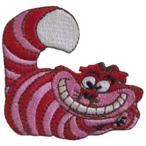 May include: Embroidered patch of the Cheshire Cat from Alice in Wonderland. The cat is red and pink with a wide grin and large eyes. The cat's tail is curled up behind it.