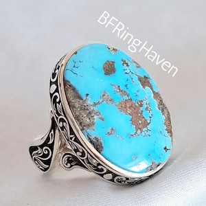 May include: A large, oval turquoise ring with a silver band. The turquoise stone is a vibrant blue with brown matrix patterns. The silver band features intricate, swirling designs. The text "BFRingHaven" is visible on the image.