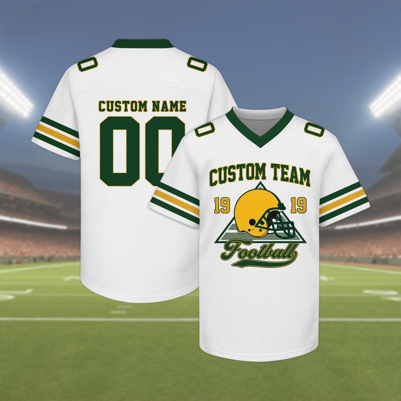 May include: White football jersey with green and gold accents. The jersey features the text "CUSTOM NAME" and the number "00" on the back. The front displays "CUSTOM TEAM" with a football helmet graphic and the word "Football".