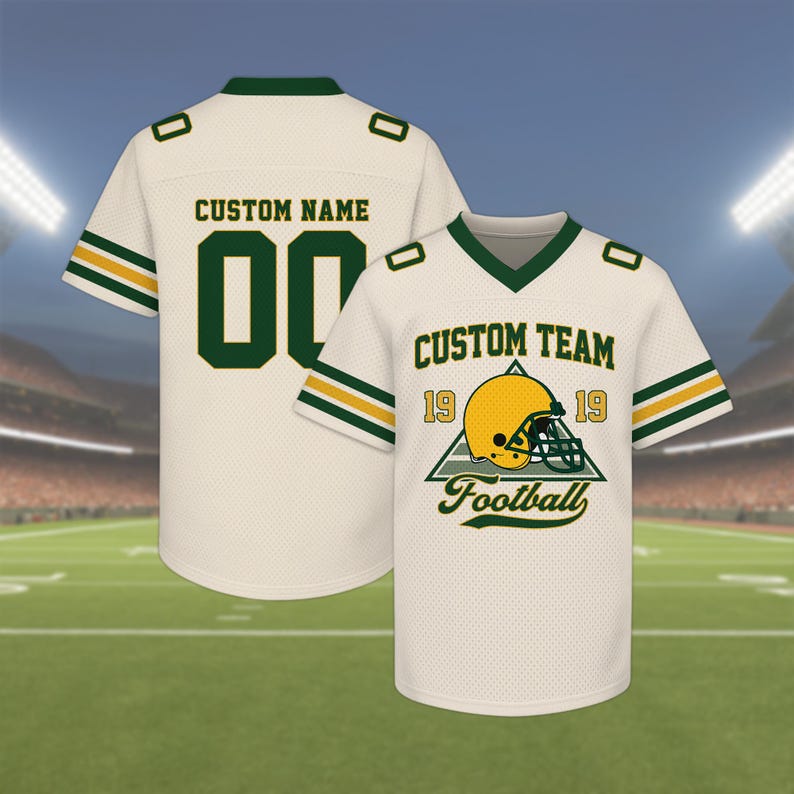 May include: Two cream-colored football jerseys. One jersey has the text "CUSTOM NAME" and the number "00" in green. The other jersey has the text "CUSTOM TEAM" and a football helmet graphic. Both jerseys have green and yellow stripes.