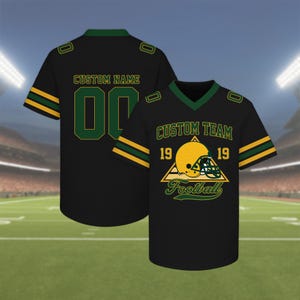 May include: Black football jersey with green and gold accents. The front features a football helmet graphic and the words "CUSTOM TEAM" and "Football". The back has the words "CUSTOM NAME" and the number "00".