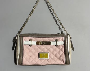 May include: A pink quilted handbag with a gold chain strap. The bag features a rectangular shape with a gold clasp and a small gold logo. The bag has white and brown accents.