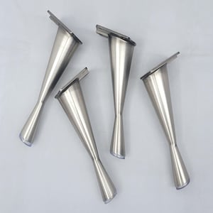May include: Four silver metal furniture legs with a modern, tapered design. Each leg has a rectangular top for mounting and a clear plastic foot. The legs are arranged on a white surface.