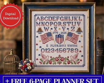 May include: Cross-stitch sampler with a blue frame featuring the alphabet, numbers, and patriotic imagery. Includes American flags, stars, and the text "E PLURIBUS UNUM". The sampler commemorates 1776-2026.