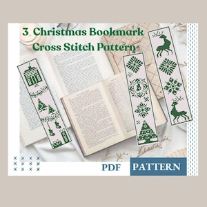 May include: Three Christmas-themed cross-stitch bookmark patterns. Each bookmark features a different design in green on a light pink background. Designs include a house, Christmas trees, snowflakes, reindeer, and a gift. The text "3 Christmas Bookmark Cross Stitch Pattern" is visible.