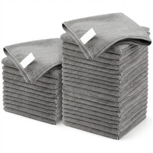 May include: Stacks of gray microfiber cleaning cloths. Each stack is neatly folded, with a white tag on the top cloth. The cloths are a solid gray color and appear soft and absorbent. Ideal for household cleaning.
