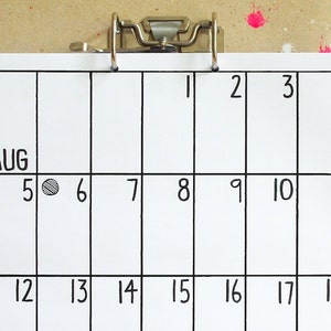May include: A black and white calendar with the month of August written at the top. The calendar has a circle drawn around the 5th.