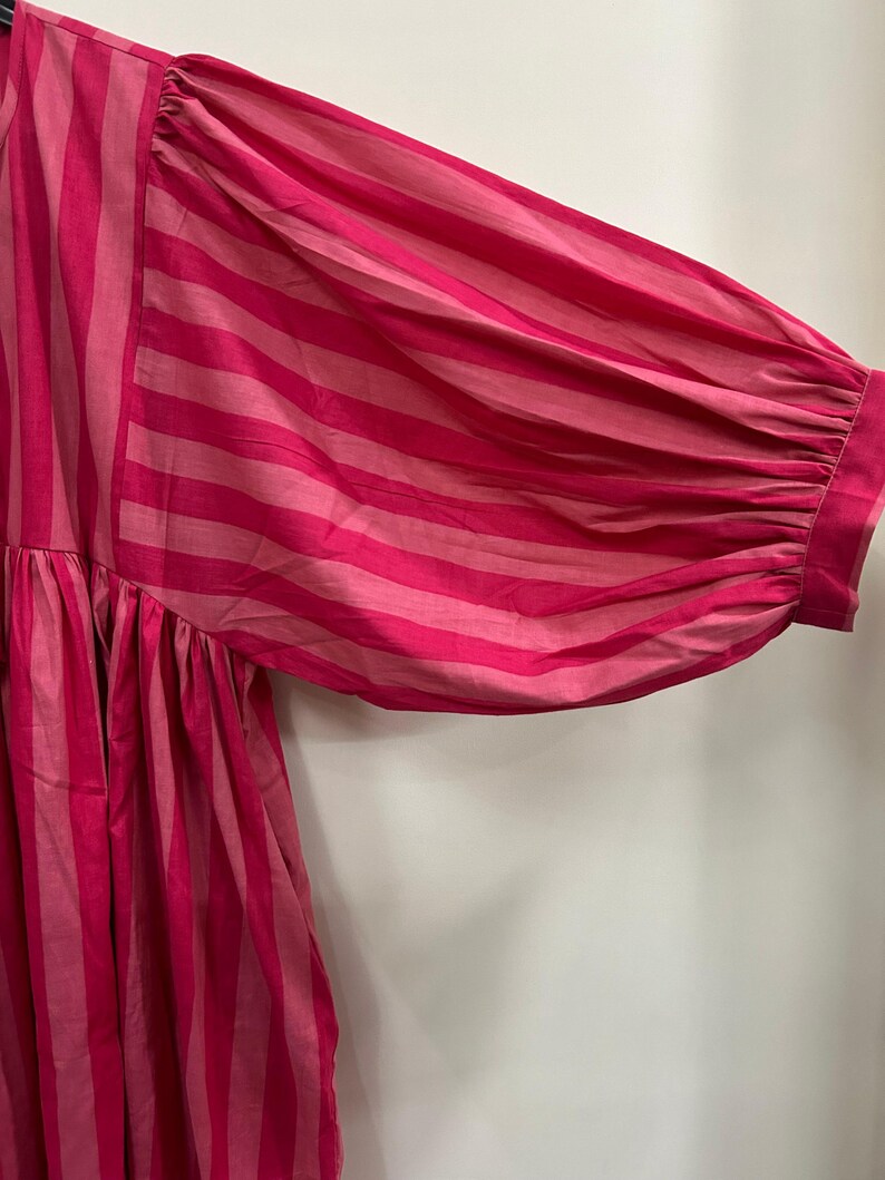 ​Eco-friendly handcrafted striped dress for sustainable style.