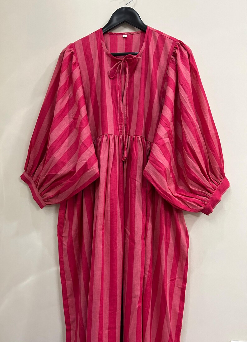 ​Artisanal midi dress with gathering at waist and cuffs.