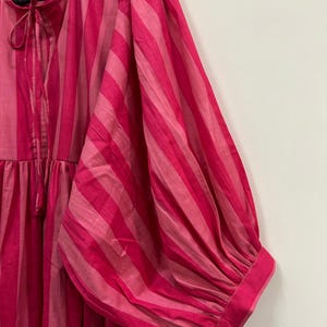 ​Stylish balloon sleeve cotton dress with side pockets.