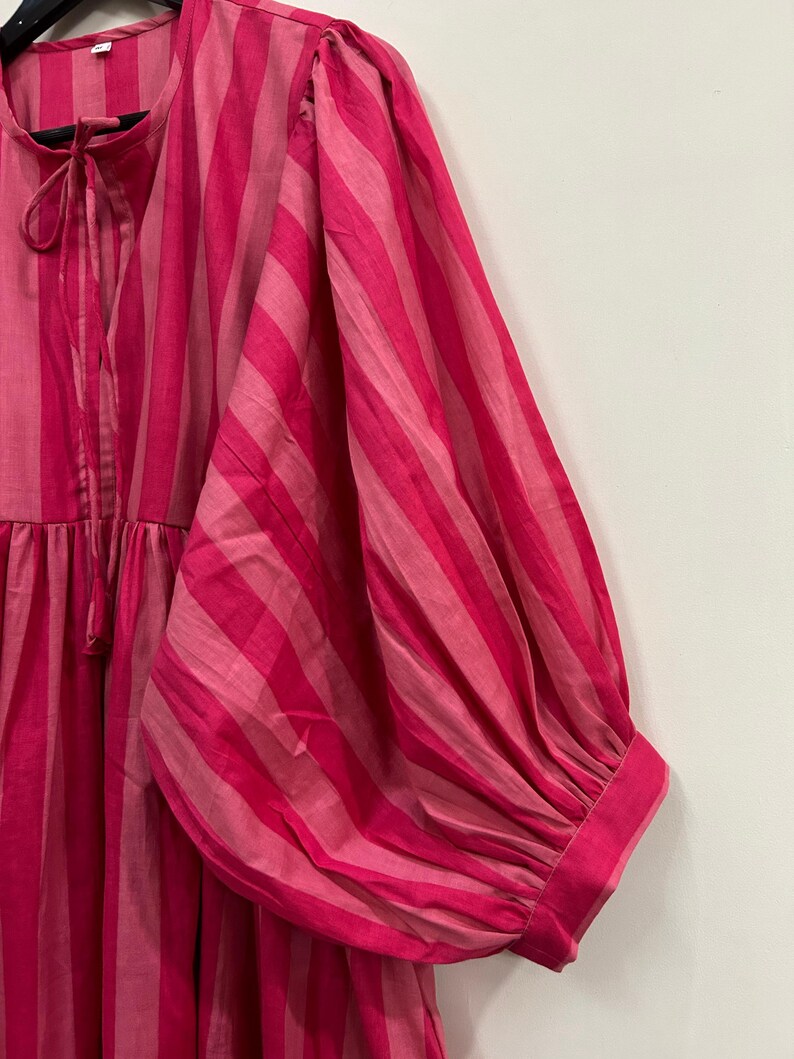 ​Stylish balloon sleeve cotton dress with side pockets.