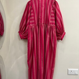 ​Detailed back view of pink striped cotton midi dress.
