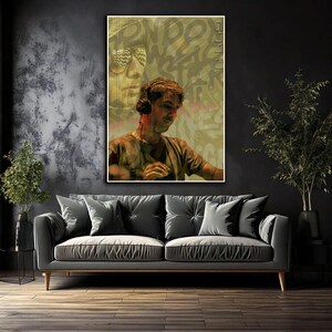 May include: A framed art print featuring a DJ wearing headphones, set against a backdrop of graffiti-style text and a faded image of a person wearing sunglasses. The color palette is dominated by muted greens, browns, and blacks.