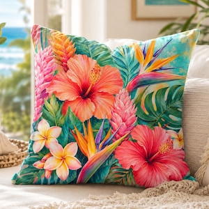 May include: A square throw pillow featuring a vibrant tropical print with large pink and orange hibiscus flowers, yellow and white plumeria, orange bird of paradise blooms, and pink ginger flowers set against a background of green palm leaves.