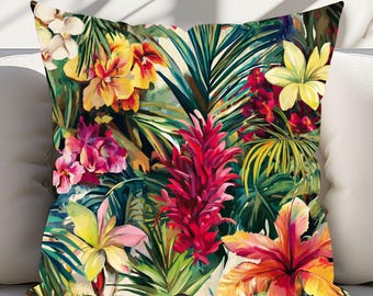 May include: A square throw pillow with a vibrant tropical floral design. The pillow features a colorful array of flowers in shades of red, yellow, pink, and orange, set against a backdrop of lush green foliage. The pillow is placed on a white surface.