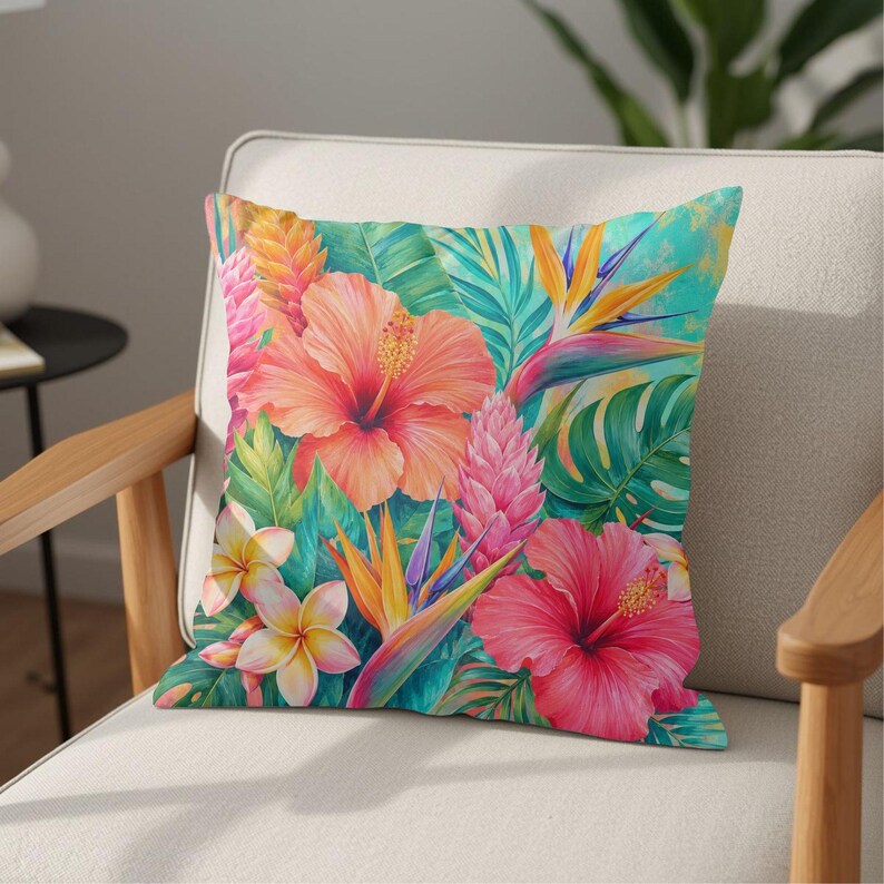May include: A square throw pillow featuring a vibrant tropical print with large pink and orange hibiscus flowers, yellow and white plumeria, bird of paradise blooms, and pink ginger stalks set against a background of lush green palm leaves.