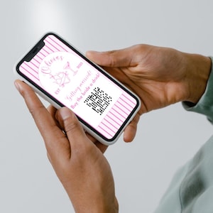 May include: A pink and white striped phone screen with a QR code and the text "Olivia EST 2023 Getting married! Buy the bride a drink!"