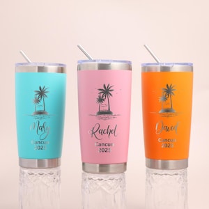 May include: Three stainless steel tumblers in turquoise, pink, and orange, each with a clear lid and straw. Each tumbler features a palm tree graphic, a name in script font, and the text Cancun 2025 engraved on the front surface.
