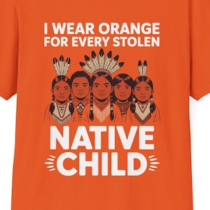 May include: Orange t-shirt with the text "I Wear Orange For Every Stolen Native Child." The shirt features a graphic of five children wearing traditional Native American headdresses. The text and graphic are in white.