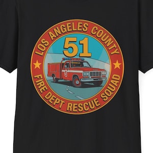 May include: Black t-shirt featuring a circular graphic of a red fire truck with the text "Los Angeles County Fire Dept Rescue Squad 51". The graphic is in a circular design with a blue background and yellow stars.