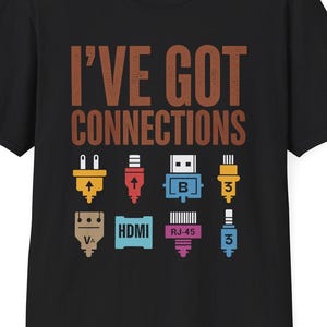 May include: Black t-shirt featuring the phrase "I'VE GOT CONNECTIONS" in brown. The design includes colourful illustrations of different electronic connectors, such as HDMI and RJ-45.