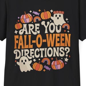 May include: Black t-shirt with a Halloween graphic. The design includes pumpkins, rainbows, a ghost, and the text "ARE YOU FALL-O-WEEN DIRECTIONS?" in orange and white. The shirt has a crew neck and short sleeves.