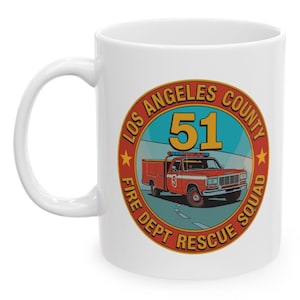 May include: White ceramic mug featuring a circular design with the text "LOS ANGELES COUNTY FIRE DEPT RESCUE SQUAD" and the number "51". The design includes a red fire truck illustration.