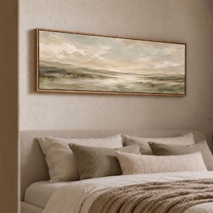 May include: A panoramic landscape painting in a wooden frame featuring a muted color palette of soft greens, beiges, and creams. The artwork depicts a wide, open field under a cloudy sky with visible brushstrokes creating a textured appearance.