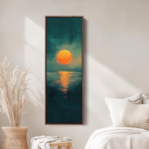 May include: A framed vertical canvas art print depicting a sunset over the ocean. The artwork features an orange sun, teal sky, and dark teal water with reflections. The frame is a dark brown color.
