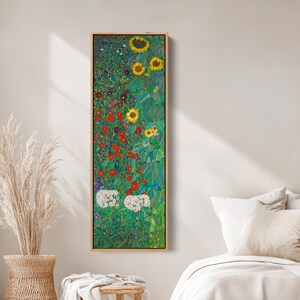 May include: A framed vertical art print featuring a vibrant floral design. The artwork showcases sunflowers, red flowers, and white blossoms against a green background. The print is encased in a light brown wooden frame, adding a touch of warmth to the piece.