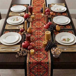 May include: A dining table set for a festive occasion. The table features white plates, silverware, and placemats. A patterned runner with red, orange, and gold hues runs down the center, adorned with candles, fruit, and decorative elements.