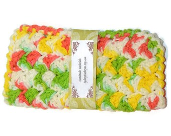May include: A handmade crocheted dishcloth in a colorful pattern of pink, yellow, green, and white. The dishcloth has a label that reads "Handmade Washcloth SydneyKathryns.etsy.com".