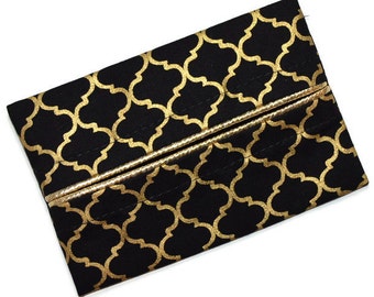 May include: Black tissue box cover with a gold geometric pattern. The cover has a gold trim around the edges.