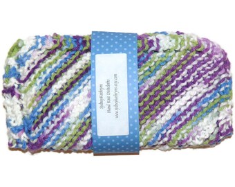 May include: A hand-knitted dishcloth in a colourful striped pattern of purple, green, blue, and white. The dishcloth is packaged with a blue label that reads "SydneyKathryns Hand Knit Dishcloths www.sydneykathryns.etsy.com".