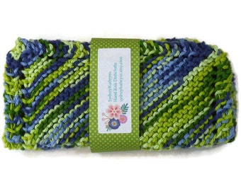 May include: A green, blue and light blue knitted dishcloth with a label that reads "Sydney Kathryns Hand Knit Dishcloths sydneykathryns.etsy.com"