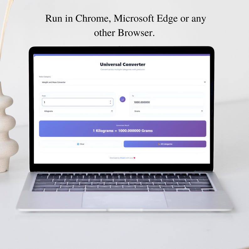 May include: A silver laptop displays a webpage for a universal converter. The screen shows a conversion from 1 kilogram to 1000.000000 grams. The text at the top reads "Run in Chrome, Microsoft Edge or any other Browser."