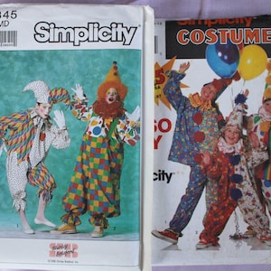 May include: Two Simplicity sewing pattern envelopes for clown costumes. The left envelope, number 9345, shows two figures in colorful jester and clown outfits. The right envelope features three figures in various clown costumes with balloons.