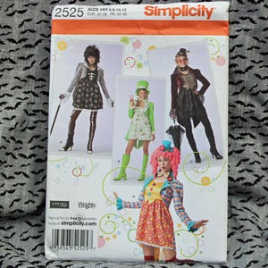 May include: Simplicity sewing pattern featuring Halloween costume designs. The pattern includes various costume options, with sizes HH 6, 8, 10, and 12. The package has a white background with images of the costumes and the Simplicity logo.