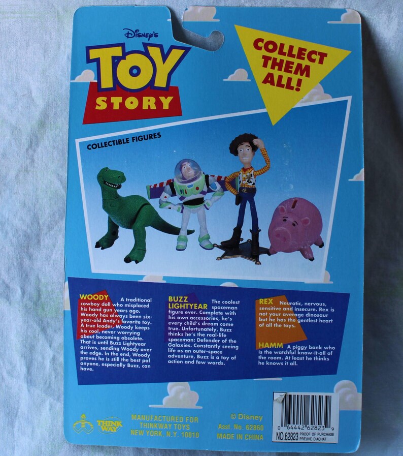 May include: A blue Toy Story collectible figure blister card back featuring illustrations of Rex, Buzz Lightyear, Woody, and Hamm. The packaging includes the Toy Story logo, the text Collect Them All!, and character descriptions for Woody, Buzz, Rex, and Hamm.