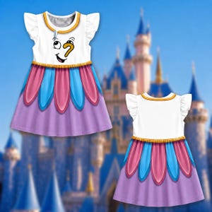 May include: A white dress with flutter sleeves featuring a graphic of a cartoon face with a yellow nose on the bodice. The skirt has a layered petal design in pink and blue over a solid lavender base. The dress is shown from both front and back.
