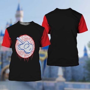 May include: Black t-shirt with red sleeves. The front displays a white and blue guitar design within a red and white circular graphic. The back is plain black with red sleeves. The design is centered on the front.