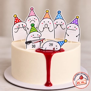 May include: A round white cake decorated with red syrup dripping down the side and several cartoon character cake toppers wearing colorful party hats. One character holds a knife with the number 30, while another lies flat with the number 29.
