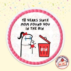 May include: A round cake with a pink frosting border and the text "18 YEARS SINCE MOM FOUND YOU IN THE BIN". The cake features a cartoon illustration of a mother and child with a red trash bin.