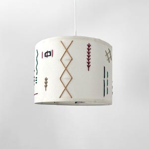 Hanging ceiling lamp. Linen shade embroidered with macramé thread.