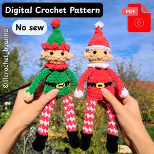 May include: Two crocheted elf dolls, one green and one red, are held up against a blurred outdoor background. The dolls have detailed features, including hats, belts, and striped legs. The image includes text that says "Digital Crochet Pattern" and "No sew".