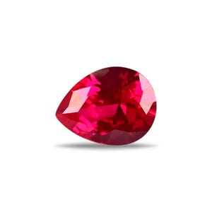 May include: A faceted, pear-shaped ruby gemstone. The gem is a vibrant, deep red colour with multiple reflective surfaces. The gemstone is set against a white background, highlighting its brilliance and clarity.