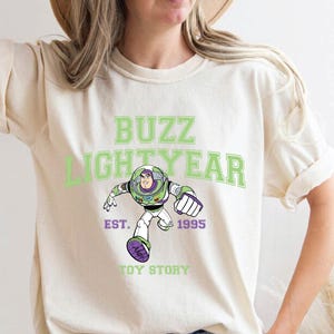 a woman wearing a buzz lightyear t - shirt