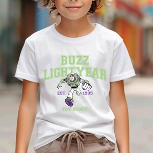 a young boy wearing a buzz lightyear t - shirt